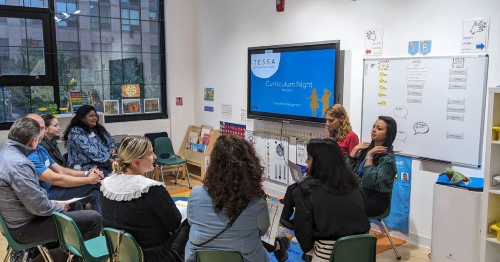 Curriculum night event with parents and teachers discussing classroom plans