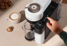 Person demonstrating how to use Nespresso machine Vertuo Lattissima.
